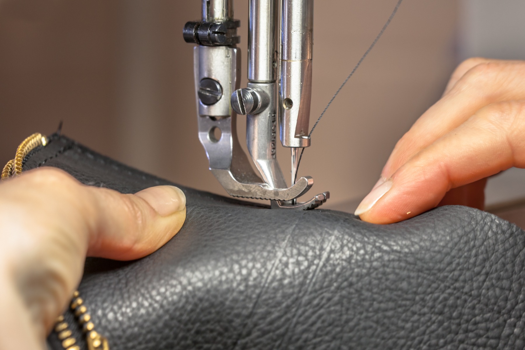an example of the care needed to sew leather together